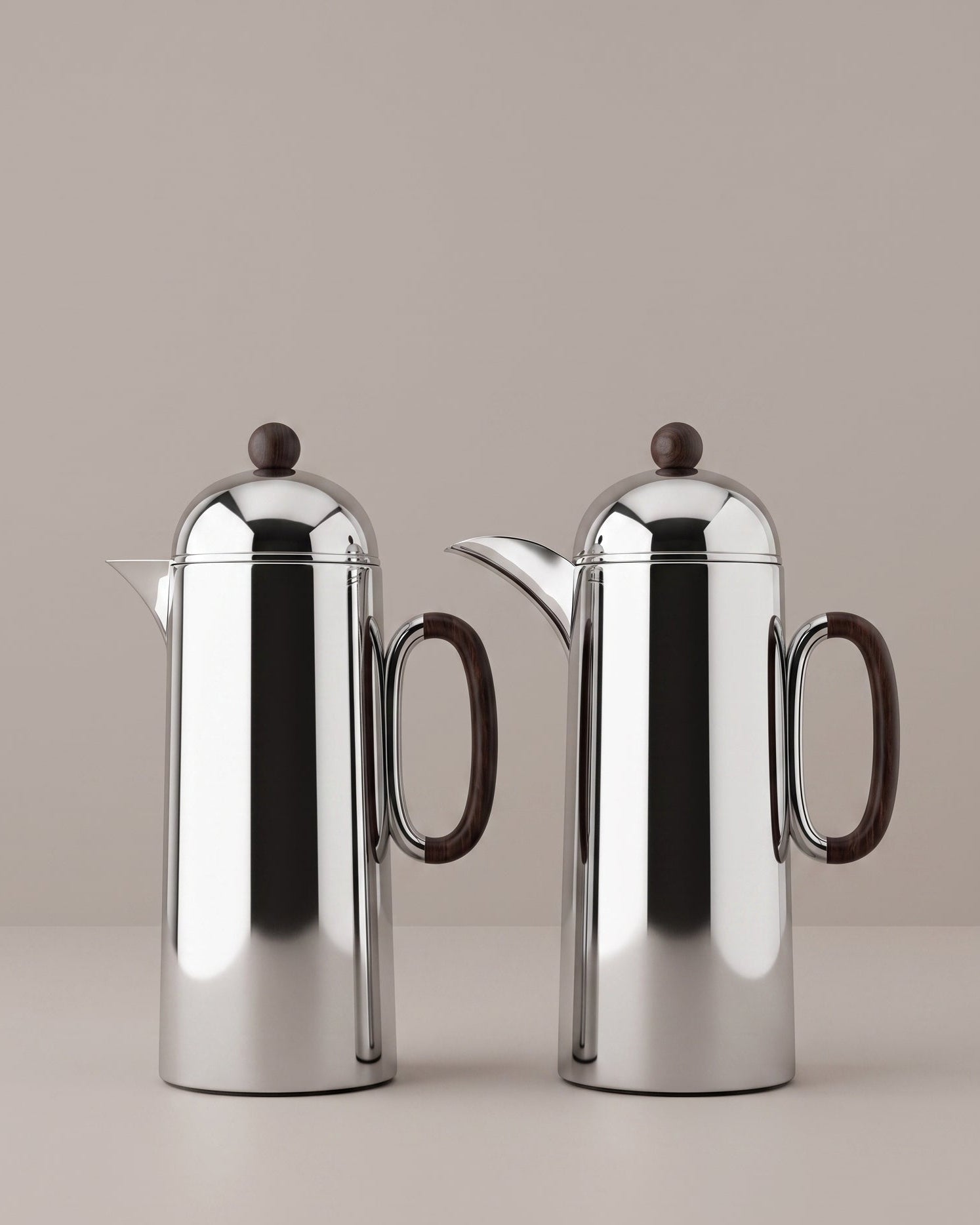 Two silver thermoses with wooden handles on a beige background